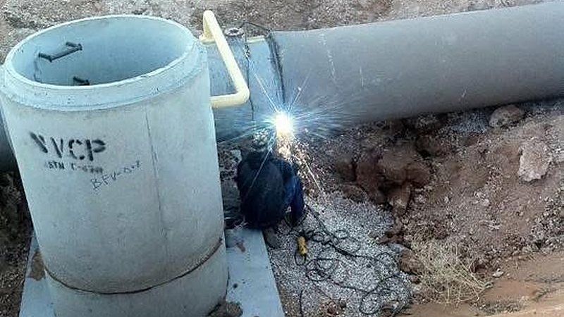 Welding large-diameter pipe down in the trench on the West Texas pipeline job
