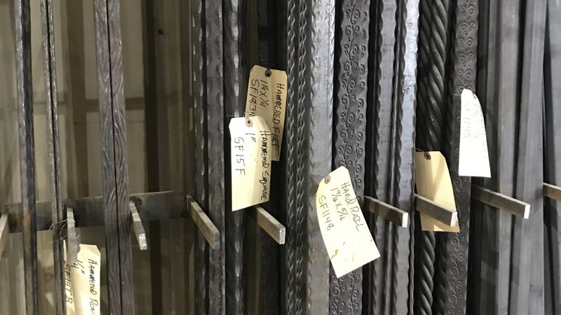 Rows of matching fabricated steel parts, tagged for shipping